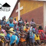 Sudanese people outside a church in the Nuba Mountains