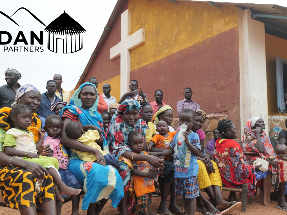 Sudanese people outside a church in the Nuba Mountains